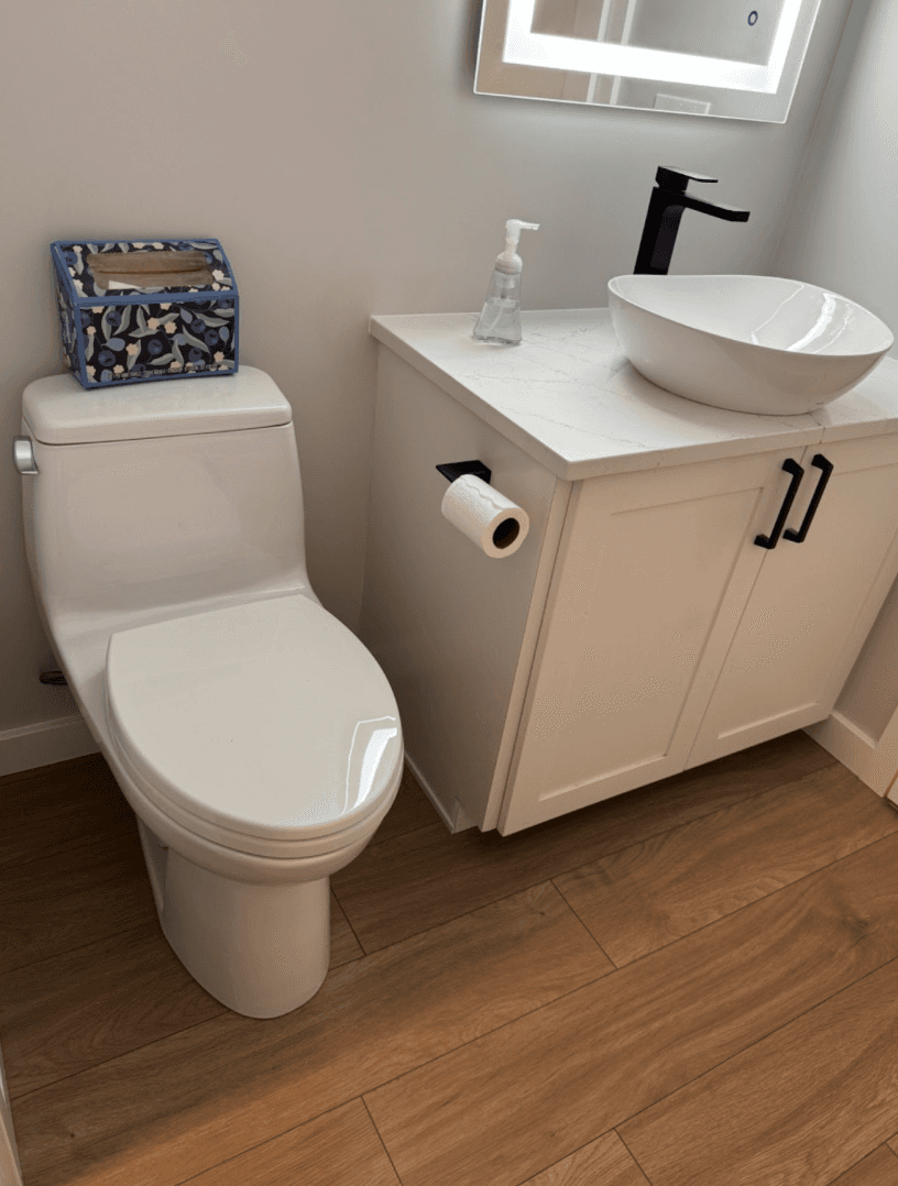 Powder room remodel with a new toilet, vessel sink vanity and wood-look tile flooring